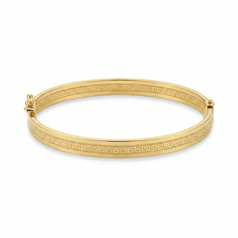 18K gold Mazimo Greek key engraved bangle bracelet with polished finish, 8.10 grams